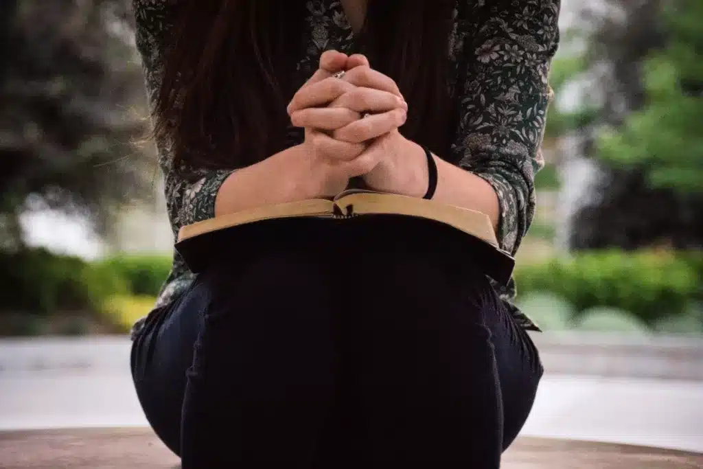 woman with Bible praying